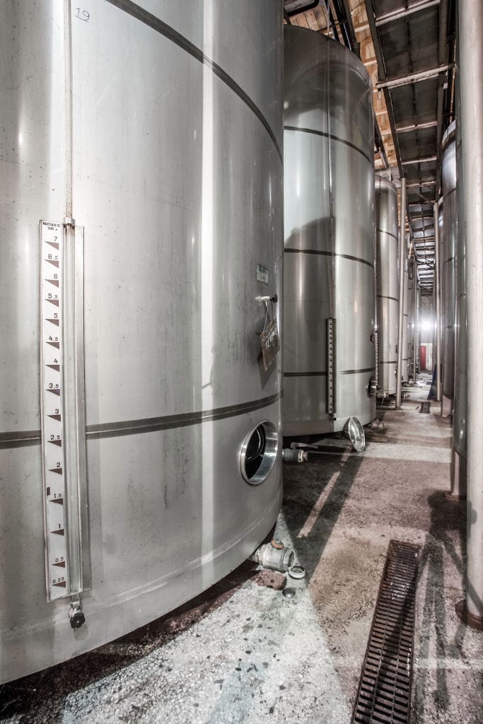 view starting at the base to on the top of aluminum wine storage tanks at 'Orealios Gaea' plant